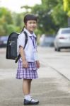 Portrait Of Asian Children Wearing Student Uniform Carrying School Backpack Toothy Smiling Face Stock Photo