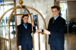 Concierge Team Holding Baggage Cart Stock Photo