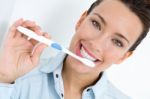 Young Woman Picking His Teeth Stock Photo