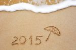 Inscription Of The Year 2015 Written In The Wet Yellow Beach Sand Stock Photo