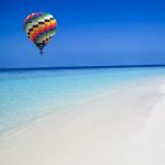 Hot Air Balloon Travel Over The Sea Stock Photo