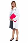 Smiling Female Physician Holding Clipboard Stock Photo