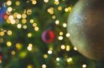 Blurred Glitter Ball Celebrate Christmas Tree With Illumination Bulb Light Background, Soft Color Cinematic Vignette Tone Stock Photo