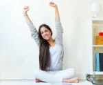 Beautiful Young Woman Waking Up And Stretching Arms At Home Stock Photo