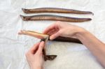 Female Hands Removing Skin Preparing Eel Fish Stock Photo