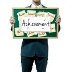 Male Holding Board With Achievement Stock Photo