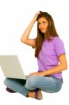 Confused Teenage Girl With Laptop Stock Photo