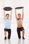 Two Young Woman Lifting Weight In Gym Stock Photo