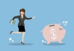 Business Woman Try To Catch Piggy Bank Stock Photo