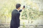 Business Man Using Mobile Phone While Standing On The Balcony In Stock Photo