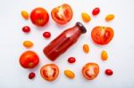 Fresh Tomatoes Juice In Bottle And Fresh Tomatoes Slices On Whit Stock Photo