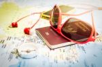 Sunglasses, Passport, Smart Phone, Earphones And Compass On The Stock Photo