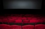 Empty Seat On Row In Thearter With Movie Screen Stock Photo
