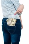 Woman Pointing At Dollar Notes In Her Back Pocket Stock Photo