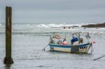 Boat And Surfers At Bude Stock Photo