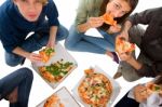 Teenagers Eating Pizza Stock Photo