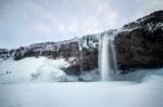 View Of Seljalandfoss Waterfall In Winter Stock Photo