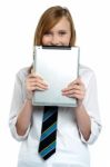 Shy Girl Hiding Her Face With A Tablet Device Stock Photo