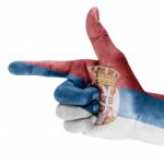 Serbia Flag On Shooting Hand Stock Photo