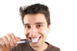 Cute Guy Washing His Teeth Stock Photo