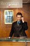 Male Receptionist Talking Phone Stock Photo
