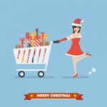 Santa Woman Push A Shopping Cart With Piles Of Presents Stock Photo