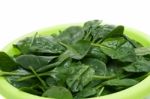 Bunch Of Fresh Spinach On A Green Bowl Stock Photo