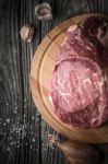 Raw Angus Beef  With Seasoning On The Wooden Table Vertical Stock Photo