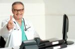 Smiling Doctor Showing Thumbs Up Stock Photo