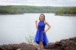 Beautiful Woman Wear Blue Evening Dress Over Mountains And River Stock Photo