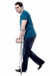 Injured Man With Crutches Stock Photo