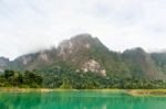Beautiful High Mountains And Green Lake Stock Photo