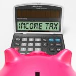 Income Tax Calculator Means Taxable Earnings And Paying Taxes Stock Photo