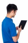 Young Guy Working On Tablet Device Stock Photo