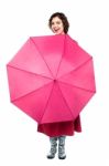 Cheerful Woman Being Playful With Umbrella Stock Photo