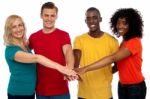 Smiling Friends Joining Hands Stock Photo