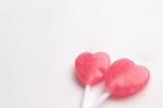 Two Pink Valentine's Day Heart Shape Lollipop Candy On Empty White Paper Background. Love Concept. Minimalism Colorful Hipster Style Stock Photo