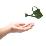 Green Eco Watering Can With Hand Stock Photo