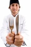 Smiling Chef Showing Knife And Fork Stock Photo
