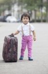 Asian Children Walking On Street With Big Suitcase Use For Journ Stock Photo