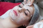 Woman Having Facial Mask At Beauty Salon Stock Photo