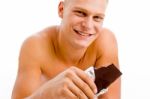 Smiling Muscular Guy With Chocolate Stock Photo