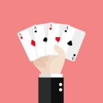 Four Aces Playing Cards In Hand Stock Photo