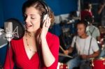 Lady Singing In Recording Studio Stock Photo
