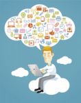 Business Man Using A Tablet Sitting On A Cloud With Social Media Stock Photo