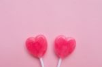 Two Pink Valentine's Day Heart Shape Lollipop Candy On Empty Pastel Pink Paper Background. Love Concept. Top View. Minimalism Colorful Hipster Style Stock Photo