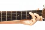 Woman's Hands Playing Acoustic Guitar Stock Photo