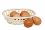 Raw Chicken Eggs Inside A Wicker Basket Stock Photo