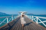 Young Woman Walking On Wooden Bridge In Si Chang Island, Thailand Stock Photo