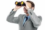 Businessman Viewing Through Binoculars Stock Photo